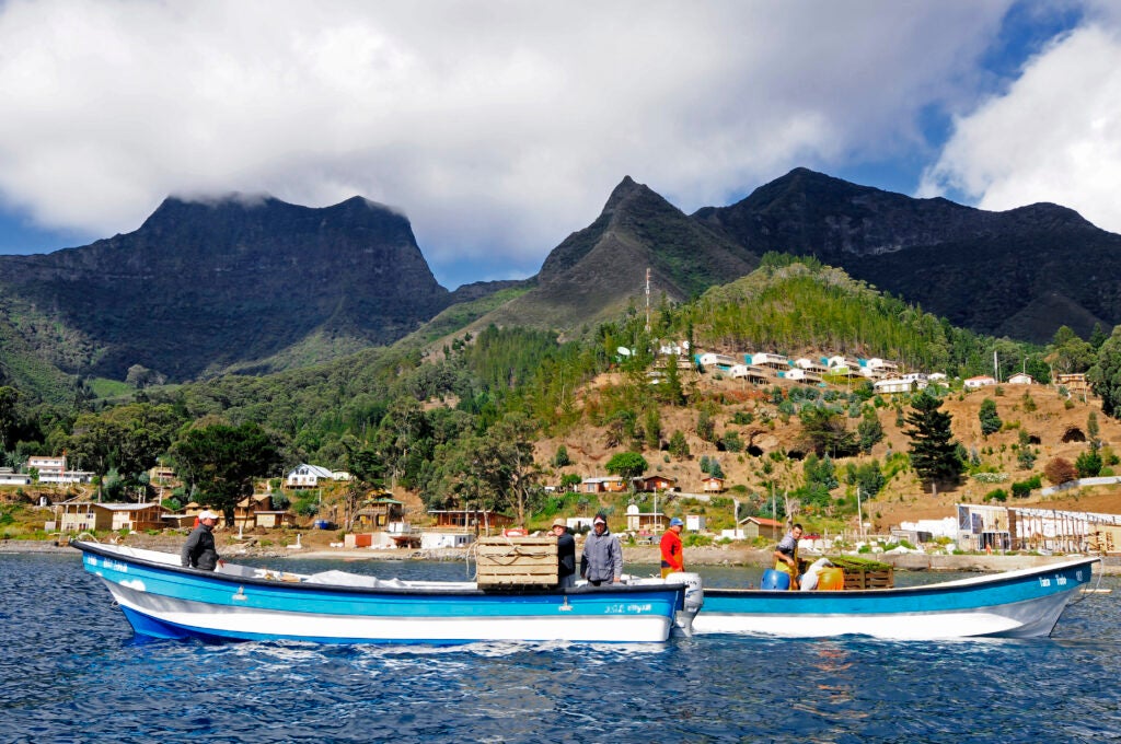 Fishers steer their boats near the island.